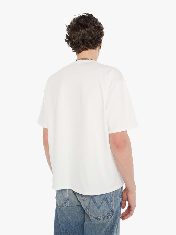 MEN back view in an oversized tee in white with hand-drawn graphic in blue and pink on the front inspired by a camp counselor tee.