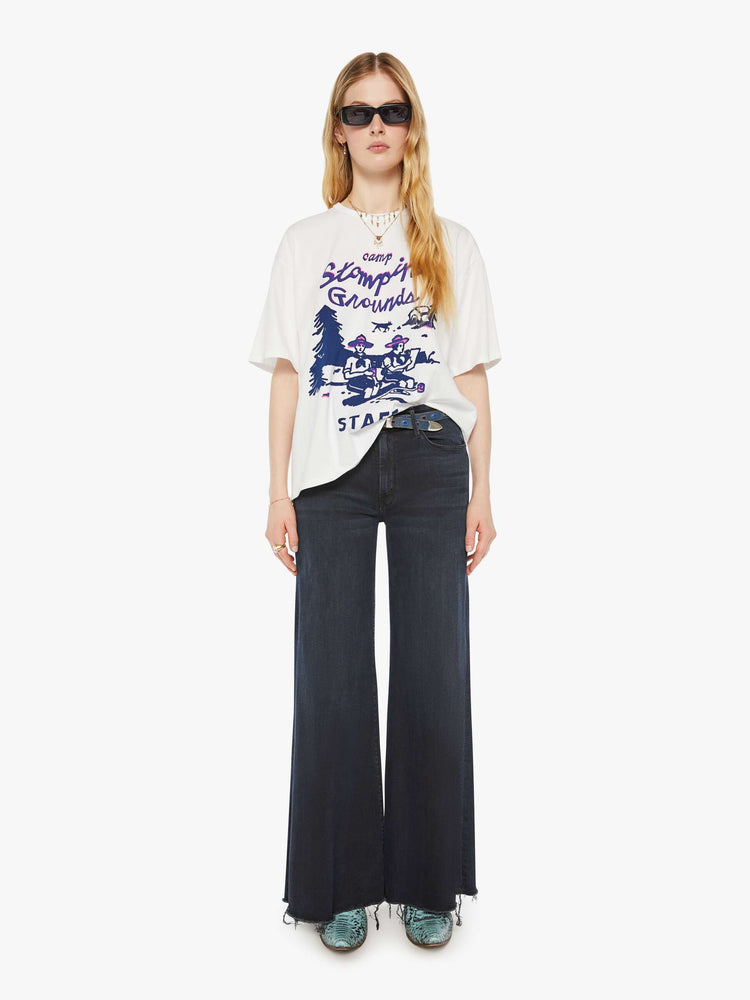 WOMAN full body view in an oversized tee in white with hand-drawn graphic in blue and pink on the front inspired by a camp counselor tee.