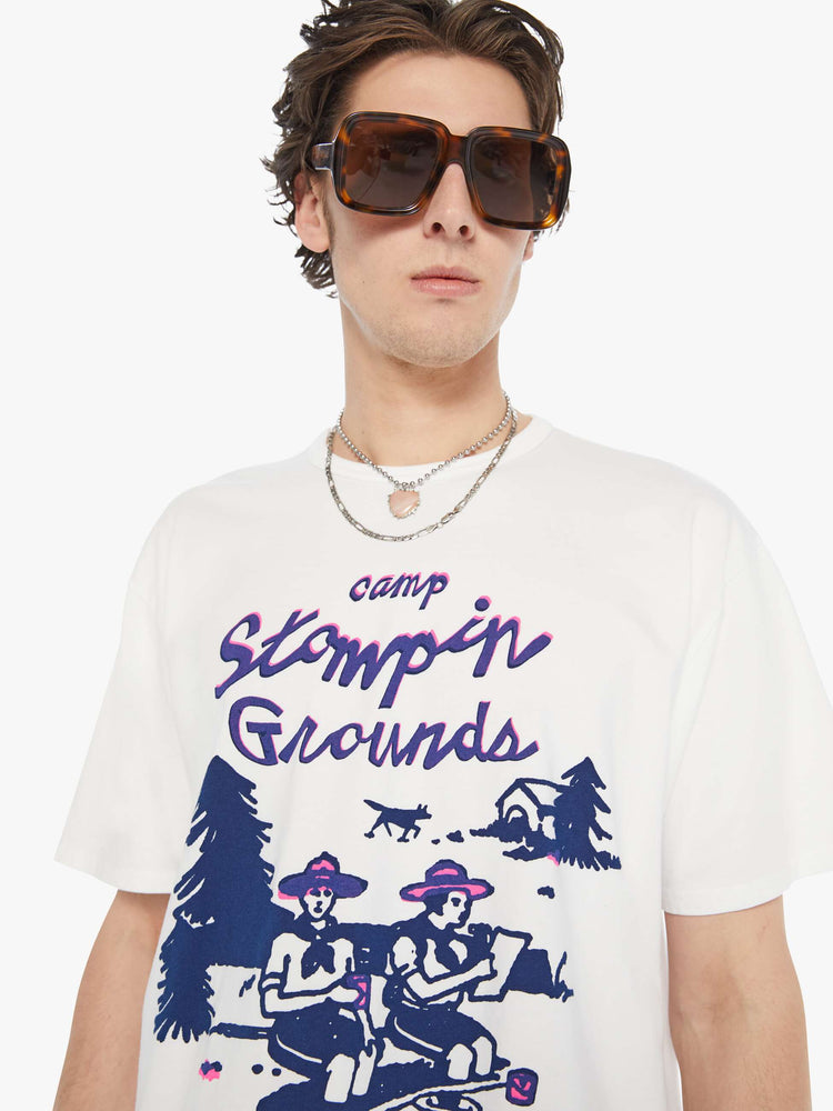MEN close up view in an oversized tee in white with hand-drawn graphic in blue and pink on the front inspired by a camp counselor tee.