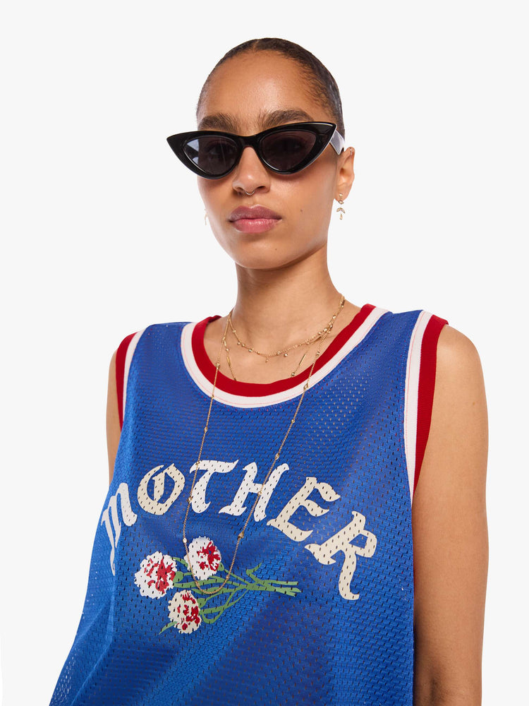 WOMAN close up view in a blue fabric with red and white trim and features MOTHER's name and a bouquet of flowers on the front sleeveless jersey.