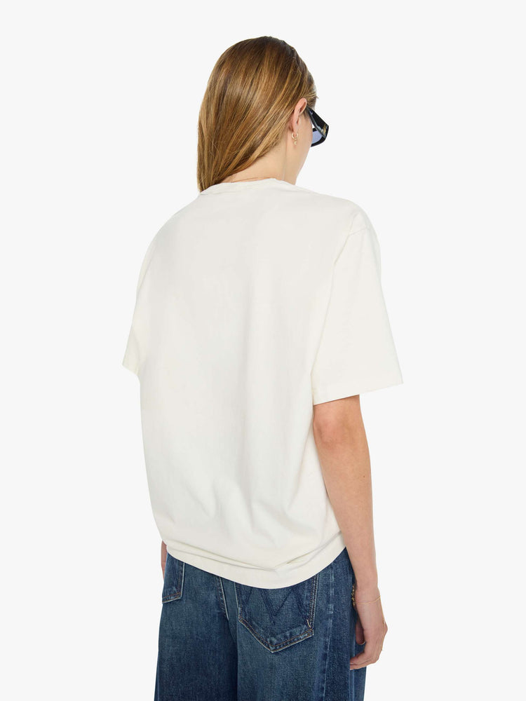 WOMAN back view in white tee features faded text and a red skydiver graphic on the front.