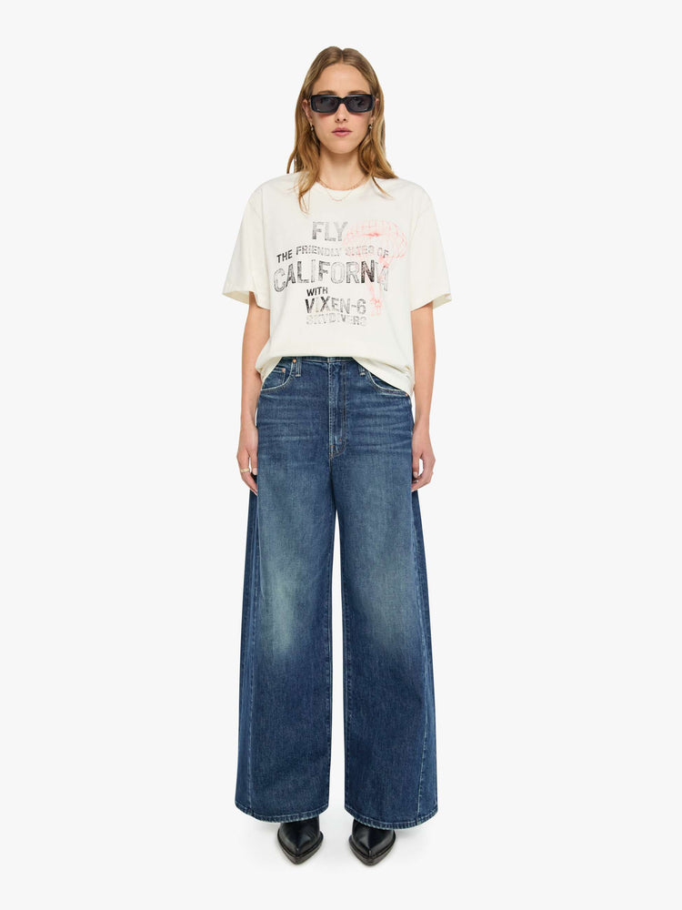 WOMAN full body view in white tee features faded text and a red skydiver graphic on the front.