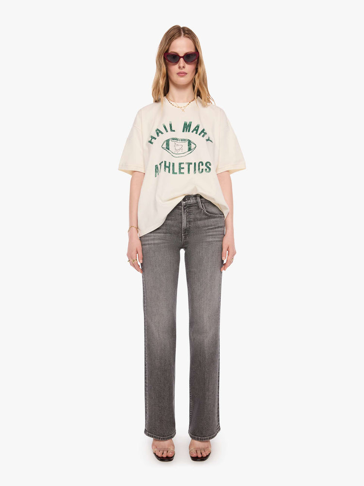 WOMAN front full body view of an off-white tee with a faded, vintage-inspired green football graphic with text on the front.