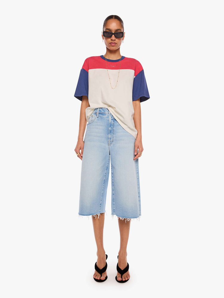 WOMAN front full view in a white tee features blue sleeves and trim and a red panel across the chest.