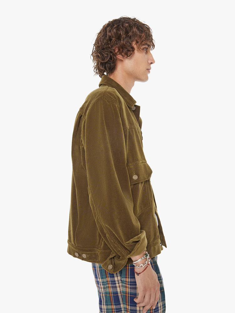 Side view of a man button-up with oversized patch pockets, drop shoulders, extra-long sleeves and a loose fit. 