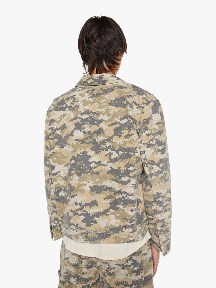 Back view of a man in a faded zip-up jacket with a front slit pocket and a boxy fit.