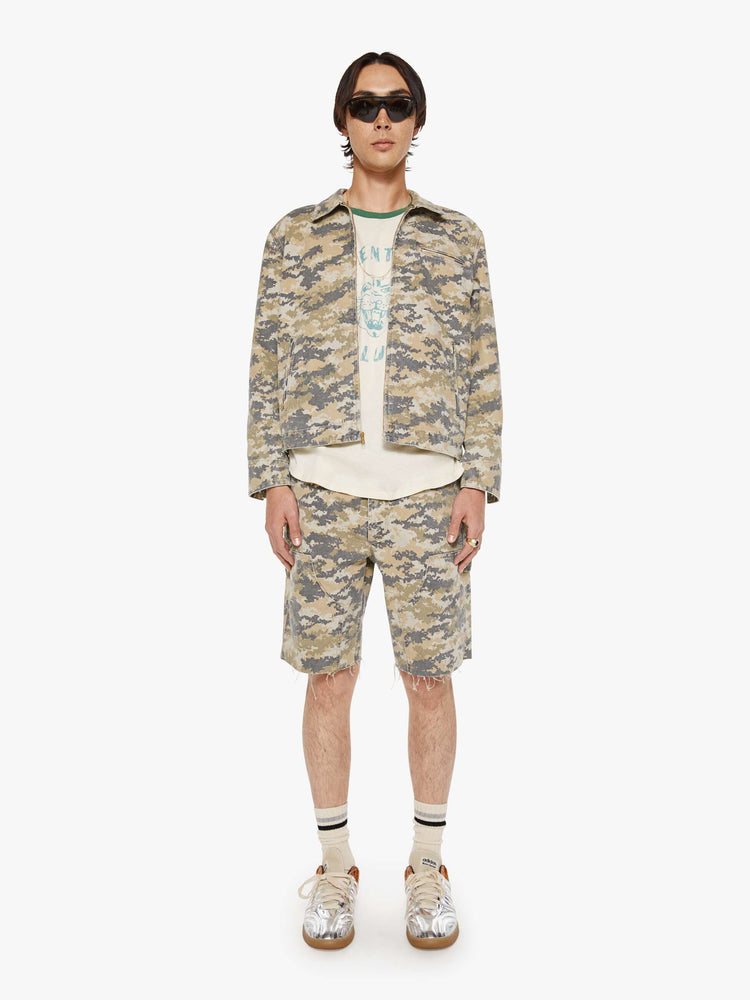 Full body view of a man in a faded zip-up jacket with a front slit pocket and a boxy fit.