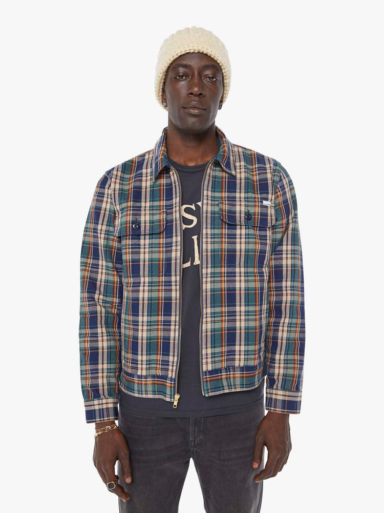Front view of a man in a plaid print zip-up jacket with patch pockets, long sleeves and a slightly cropped fit. 