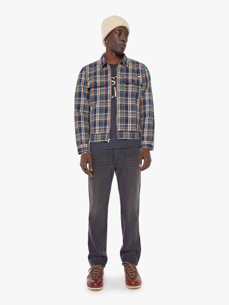 Full body view of a man in a plaid print zip-up jacket with patch pockets, long sleeves and a slightly cropped fit. 