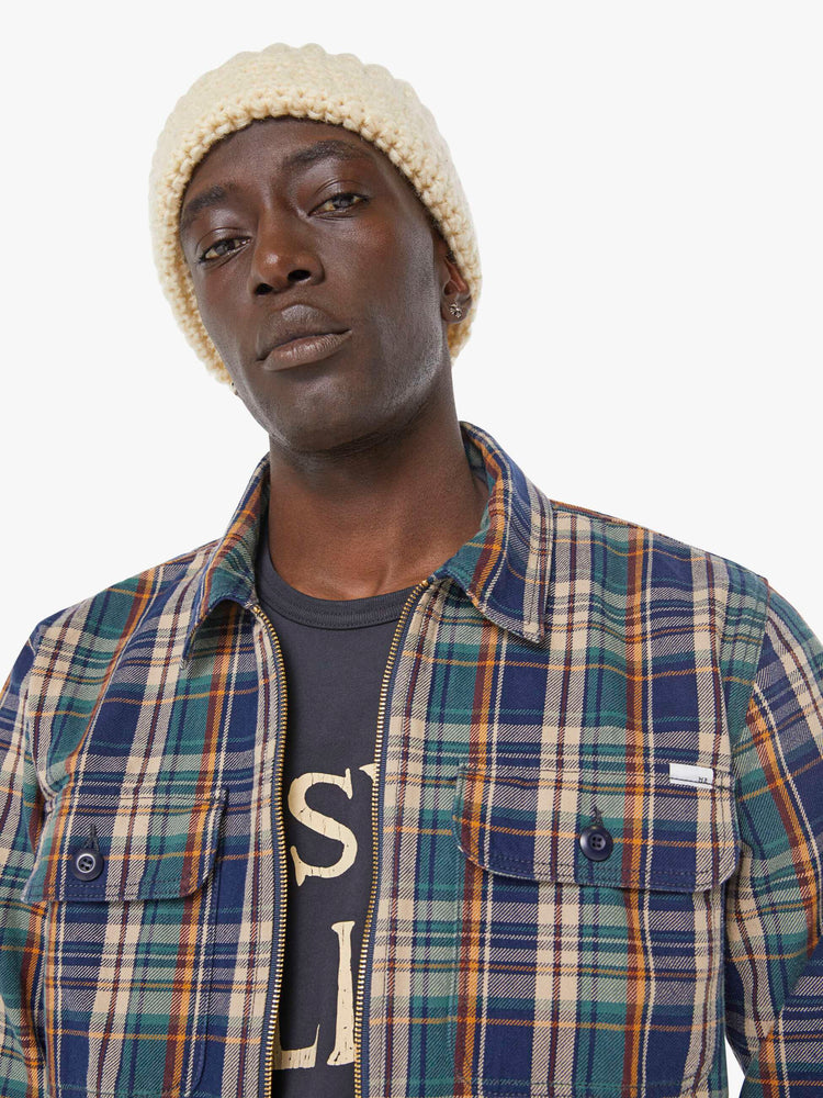 Close up view of a man in a plaid print zip-up jacket with patch pockets, long sleeves and a slightly cropped fit. 