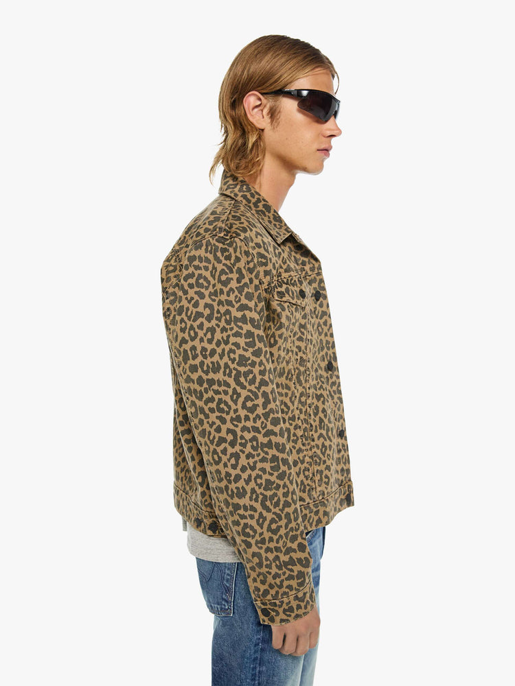 Side view of a man in a leopard print classic button-up jacket with a collared neck, patch pockets and a boxy fit.