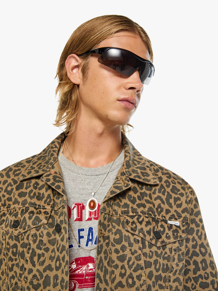 Close up view of a man in a leopard print classic button-up jacket with a collared neck, patch pockets and a boxy fit.