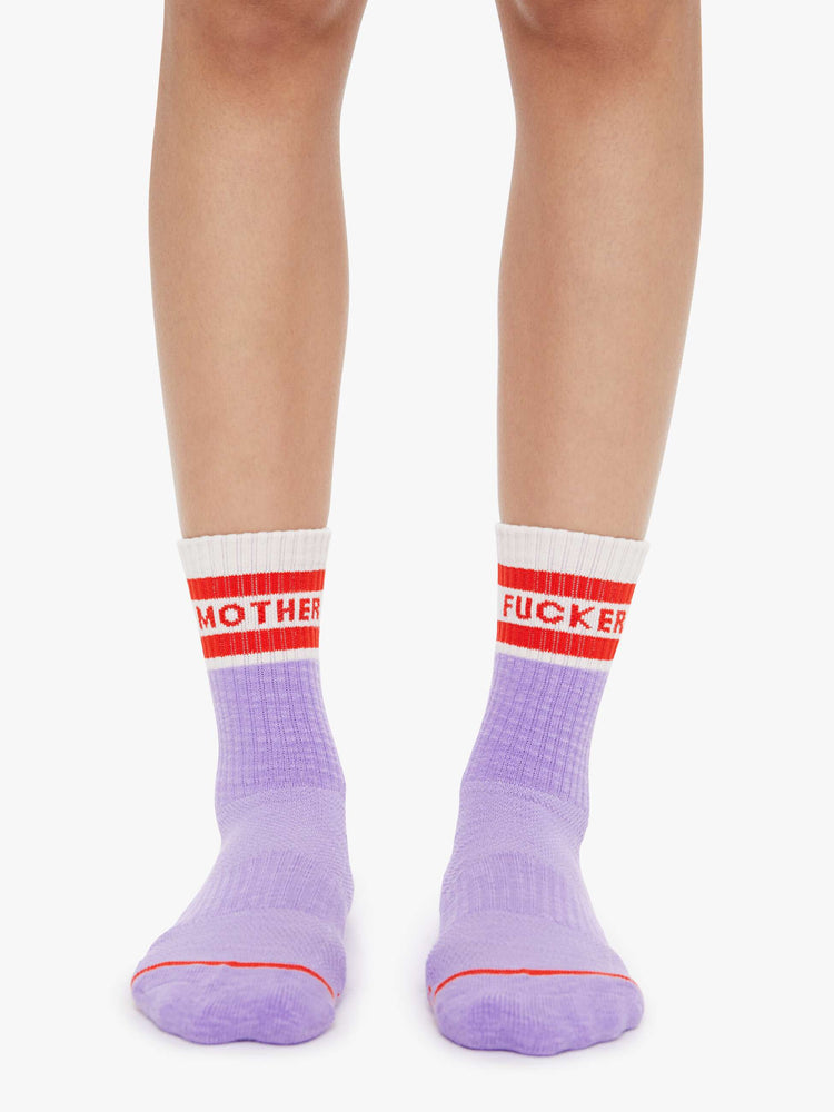 Front view of lavender and white with red lettering details socks on a model feet.