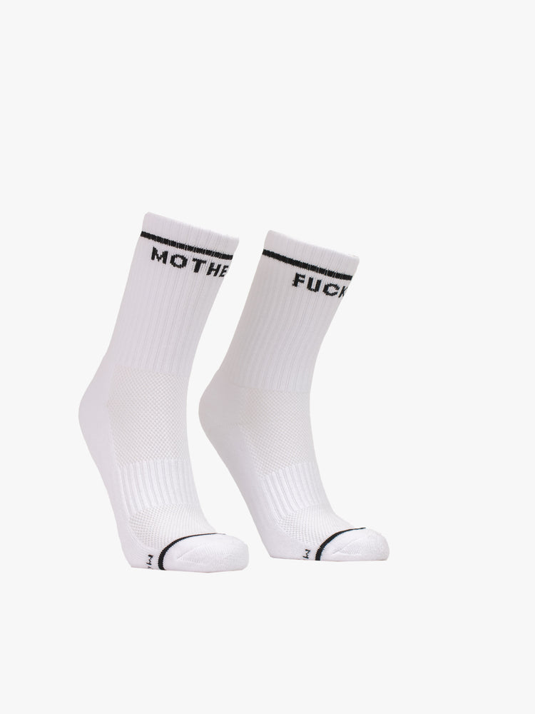 Front view of a pair of white socks with a black stripe and text along the ankle.