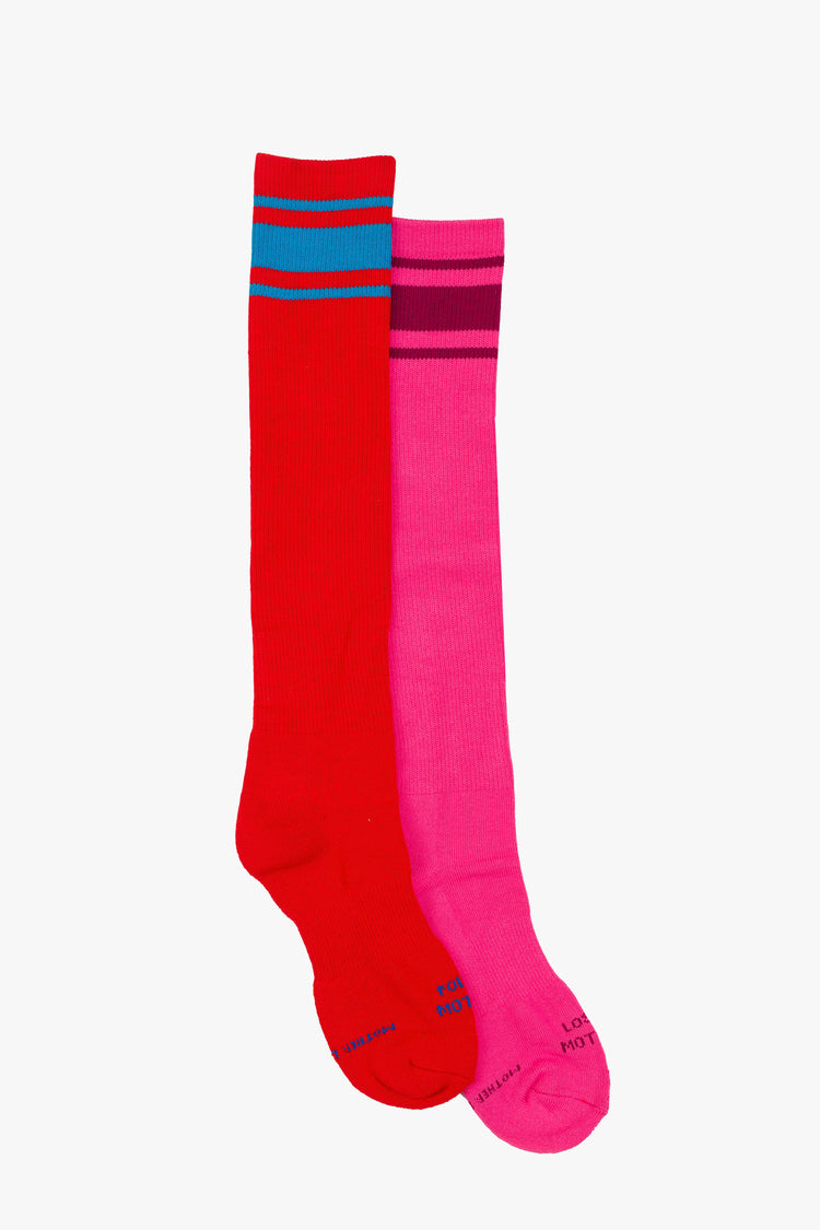 Side view of retro tube socks in shades of pink and red with burgundy and blue stripes and text on the feet.