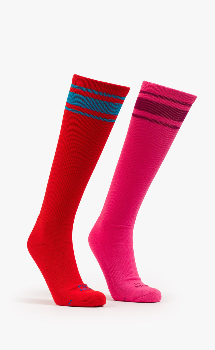 Front view of retro tube socks in shades of pink and red with burgundy and blue stripes and text on the feet.