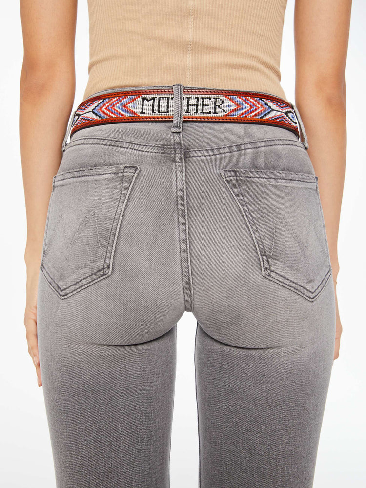 Back on model view of a vintage-inspired leather belt with embossed and beaded details. 