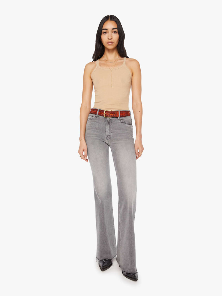 Full body of a vintage-inspired leather belt with embossed and beaded details. 