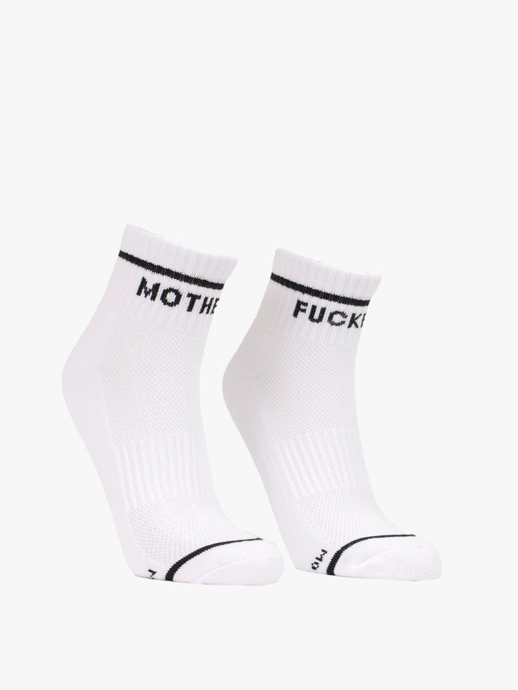 Front view of a pair of white socks with a black stripe and text around the ankle.