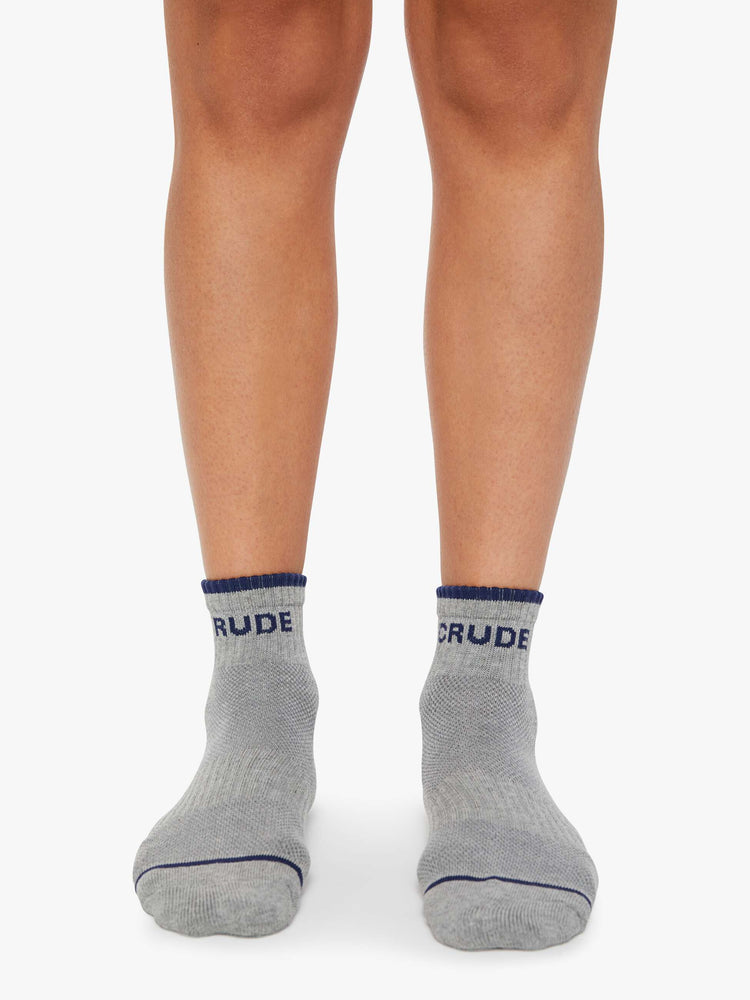 On model  MOTHER'S classic ankle-length tube sock in grey with navy text and trim.