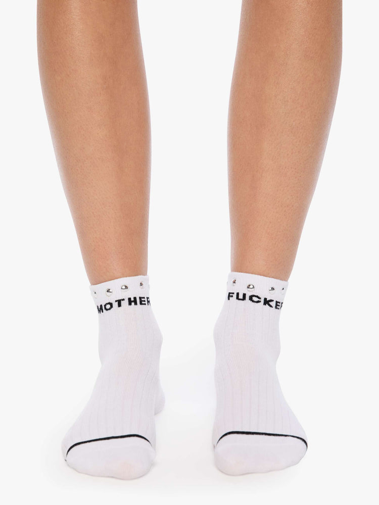 Front view of a MOTHER's classic black and white tube sock now in an ankle style with metal studs along the hem.
