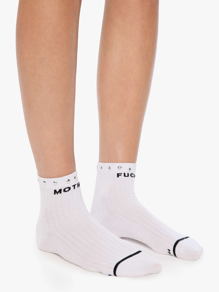 On model view of a MOTHER's classic black and white tube sock now in an ankle style with metal studs along the hem.