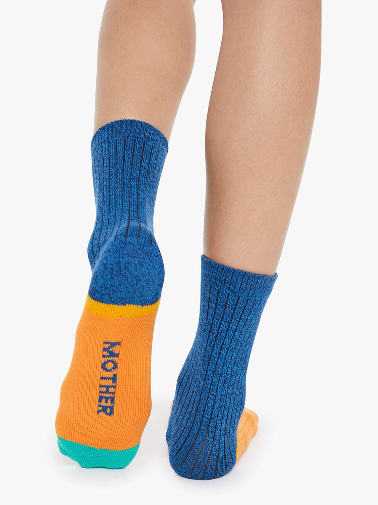 On model view of Hokey Pokey a pair of navy, orange and teal tube socks with text across the top.