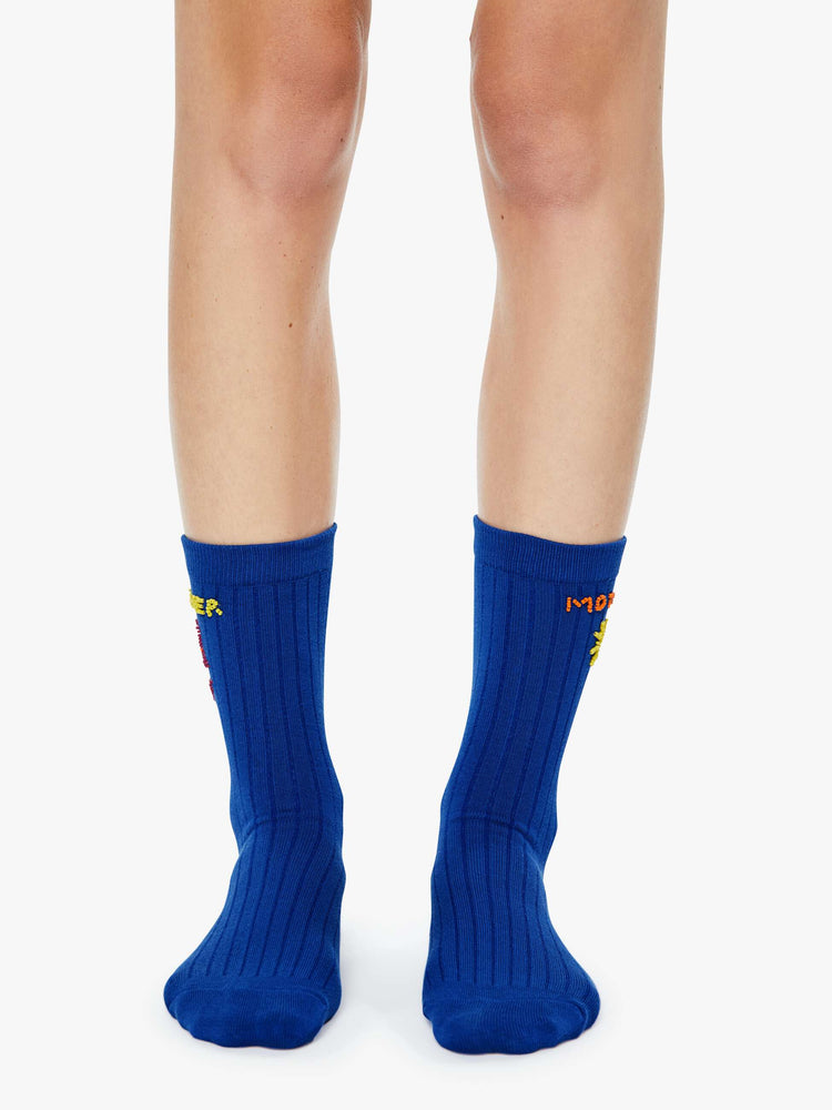 Front on model view of tube socks designed in blue with a sun, red bikini and MOTHER's name beaded on the sides.