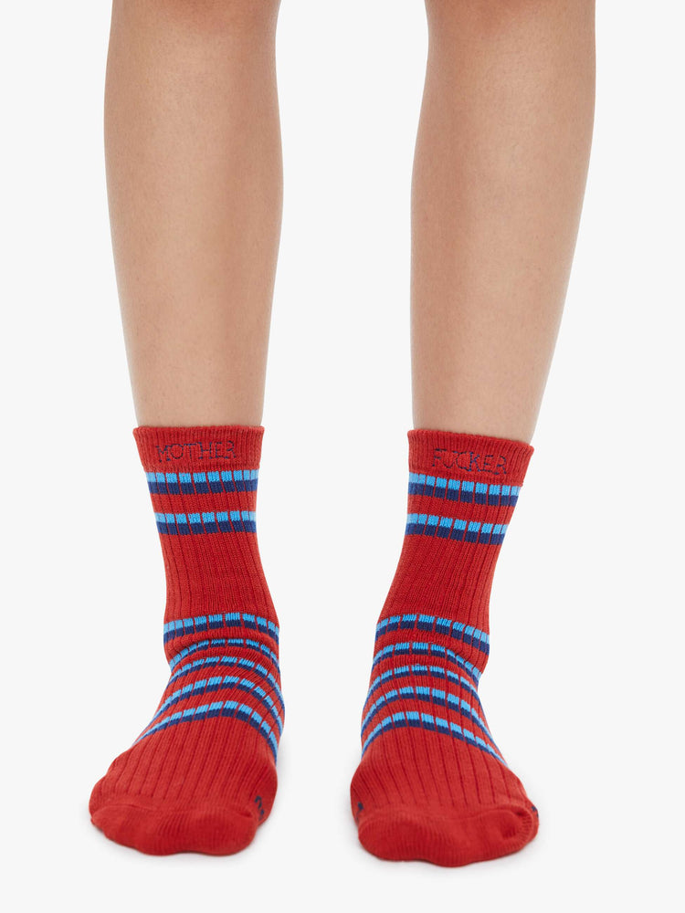 Front view of a woman in a tube socks with a message from MOTHER. Shown here in red with blue stripes and text across the top.