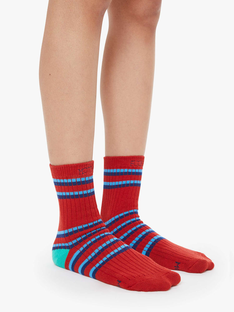 On model view of a woman in a tube socks with a message from MOTHER. Shown here in red with blue stripes and text across the top.