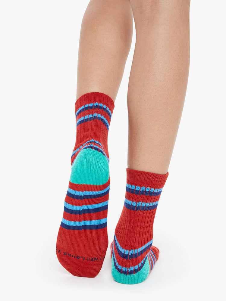 On model view of a woman in a tube socks with a message from MOTHER. Shown here in red with blue stripes and text across the top.