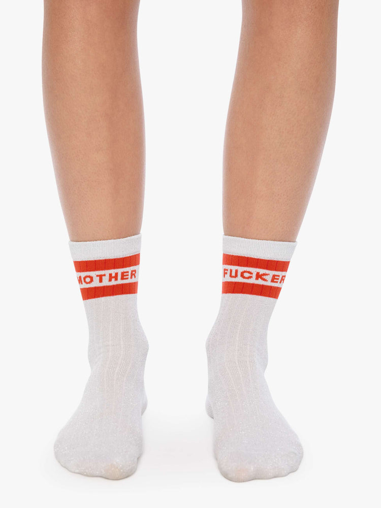 On model view of silver glitter with red stripes and text across the top.