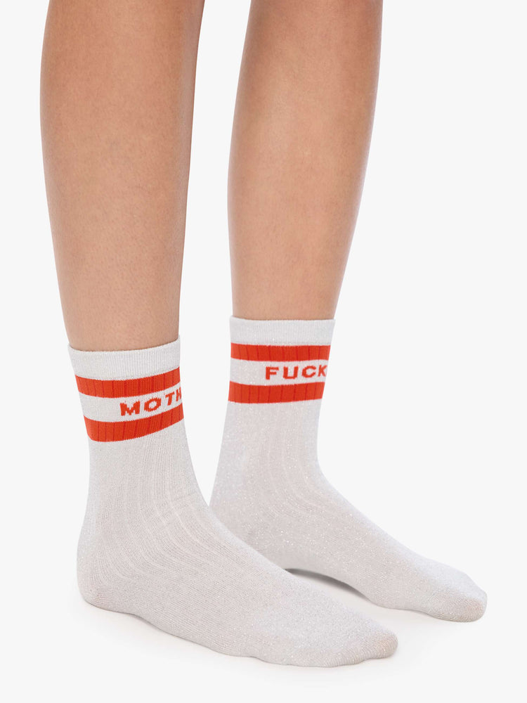 On model view of silver glitter with red stripes and text across the top.