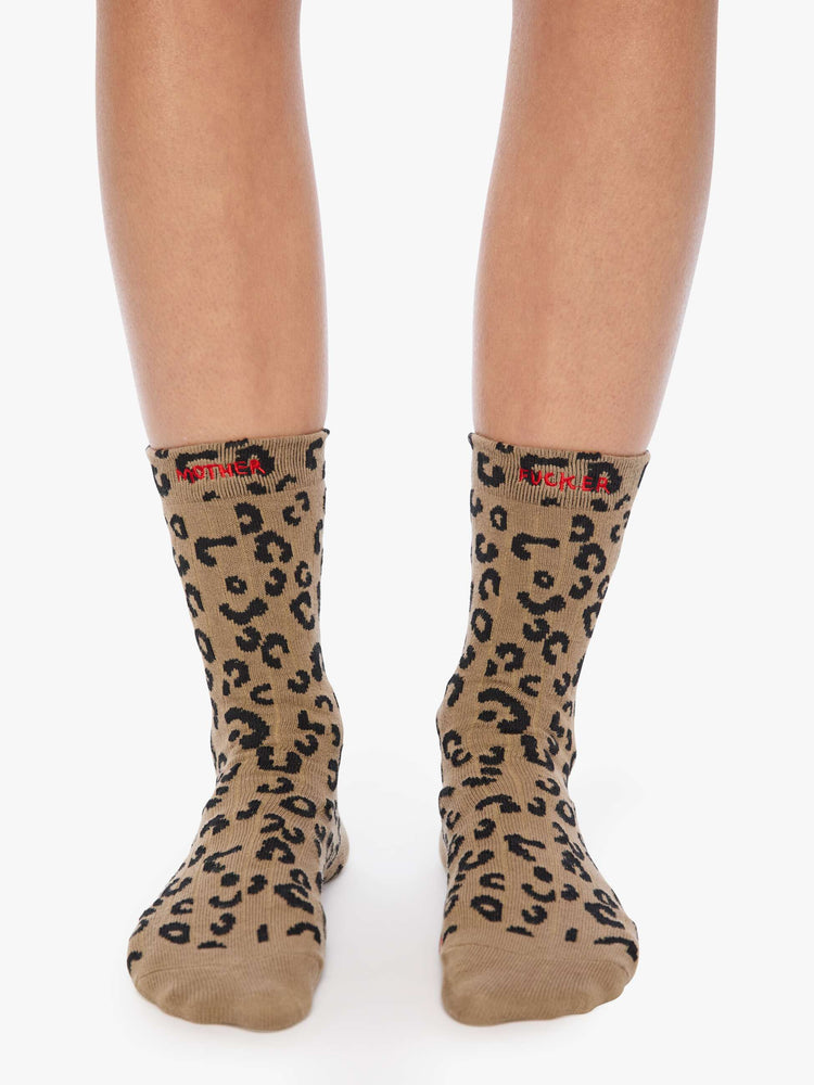 Model wearing cheetah print with red text across the top socks.