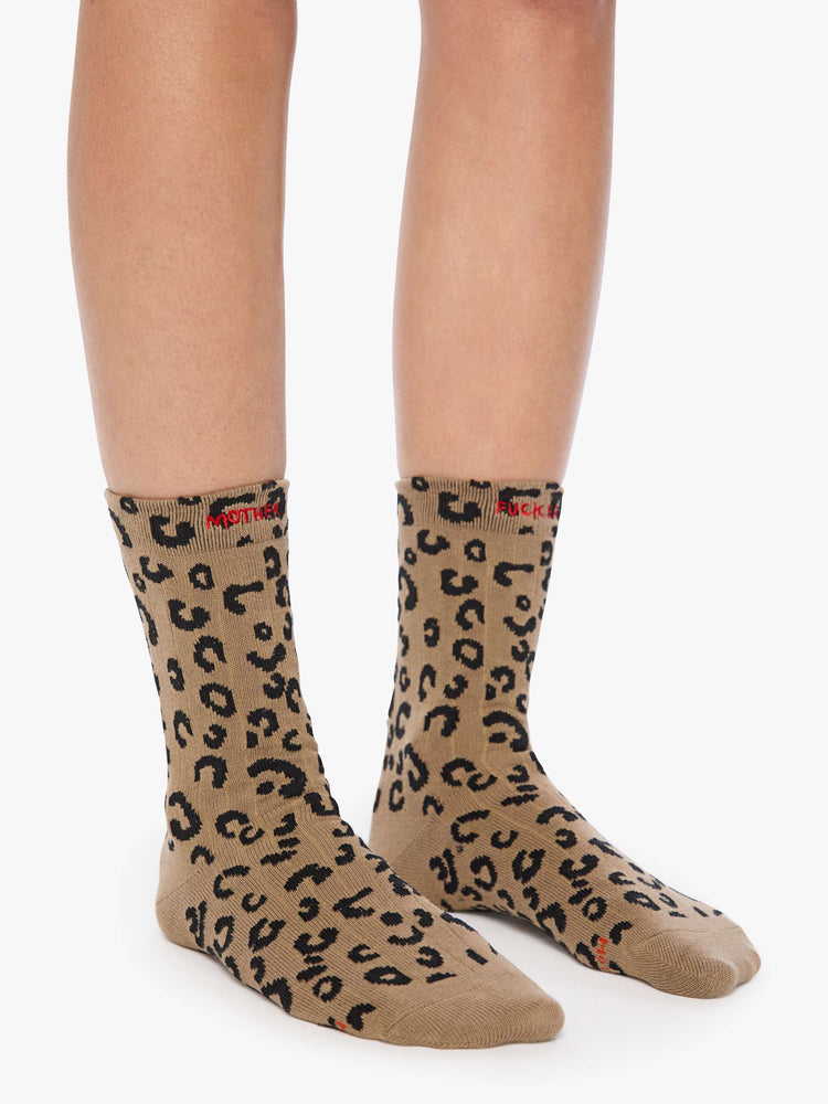On model wearing cheetah print with red text across the top socks.