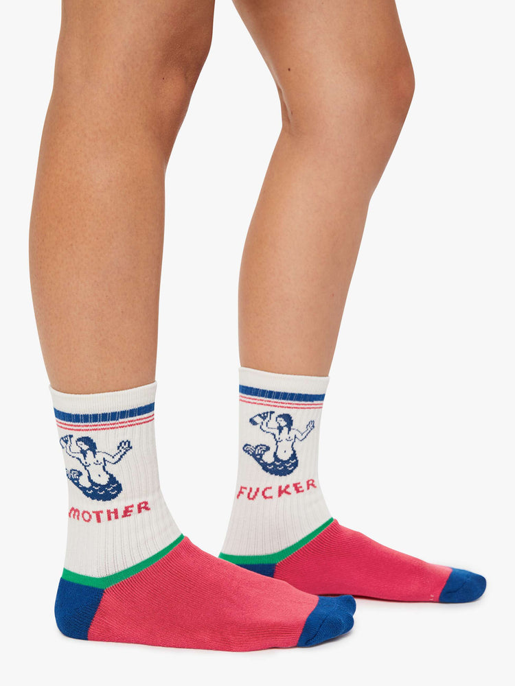 On model view of a white with red, blue and green details tube socks with an explicit message from MOTHER.