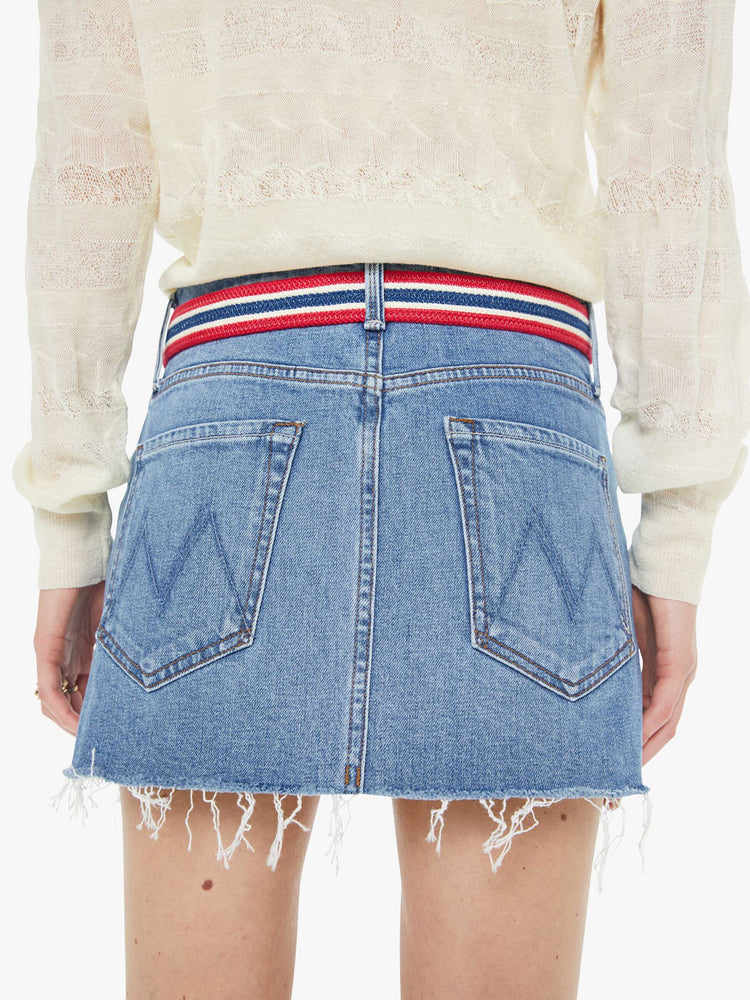 On model view of a belt in shiny gold-colored buckle and vintage vibe in red, white and navy stripes.