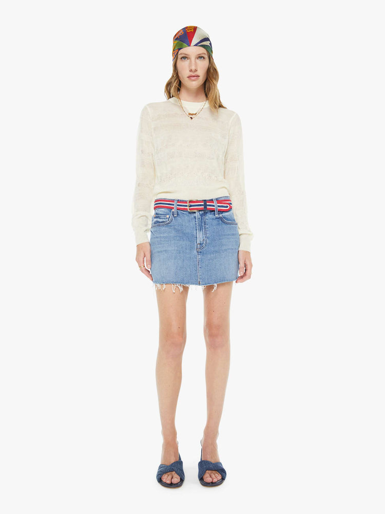 On model view of a belt in shiny gold-colored buckle and vintage vibe in red, white and navy stripes.