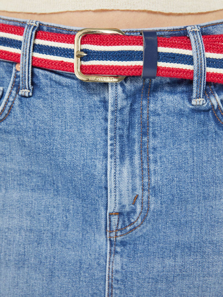Clos up on model view of a belt in shiny gold-colored buckle and vintage vibe in red, white and navy stripes.