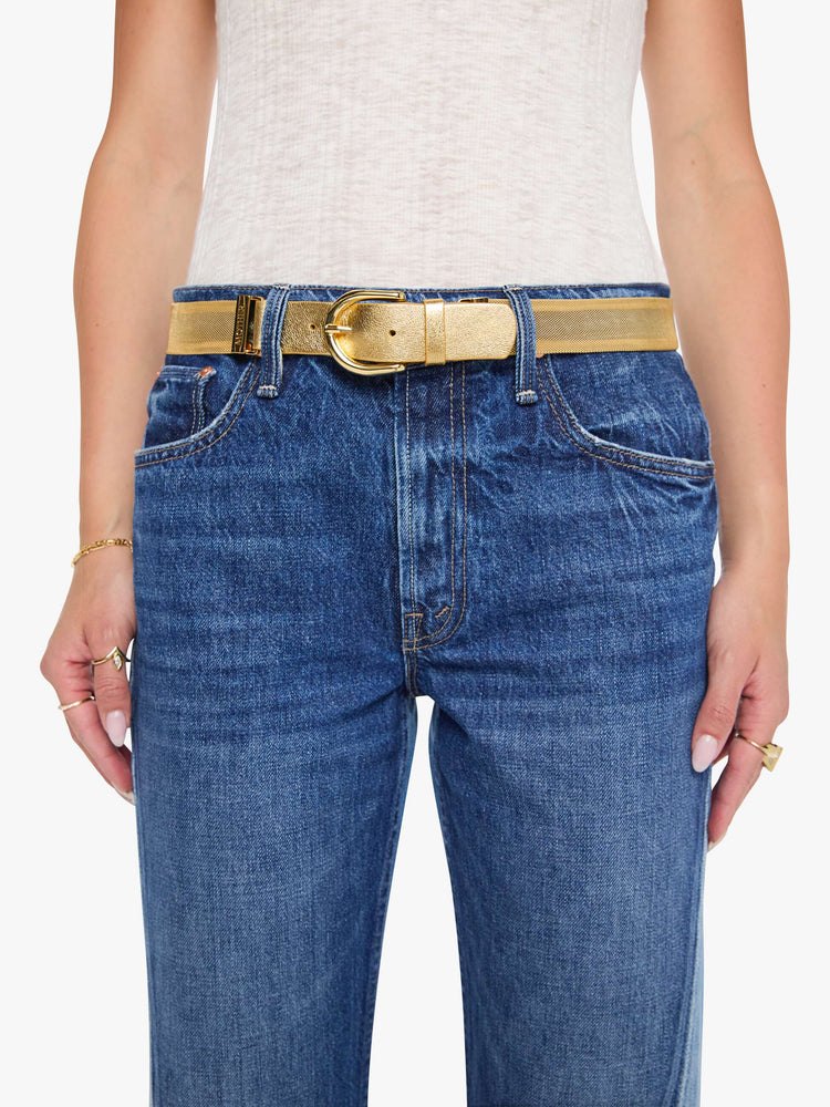 On model view of wide belt made from 100% copper chainmail with a rounded gold-tone buckle.