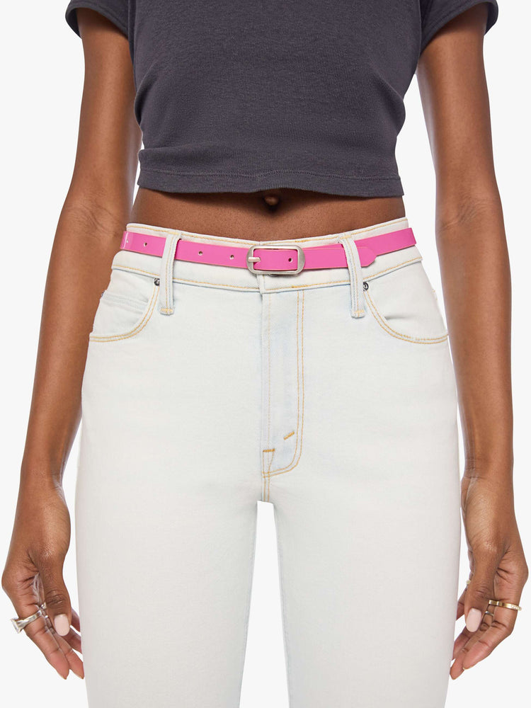 On model narrow belt is made from 100% leather with a pastel pink coating and silver hardware.