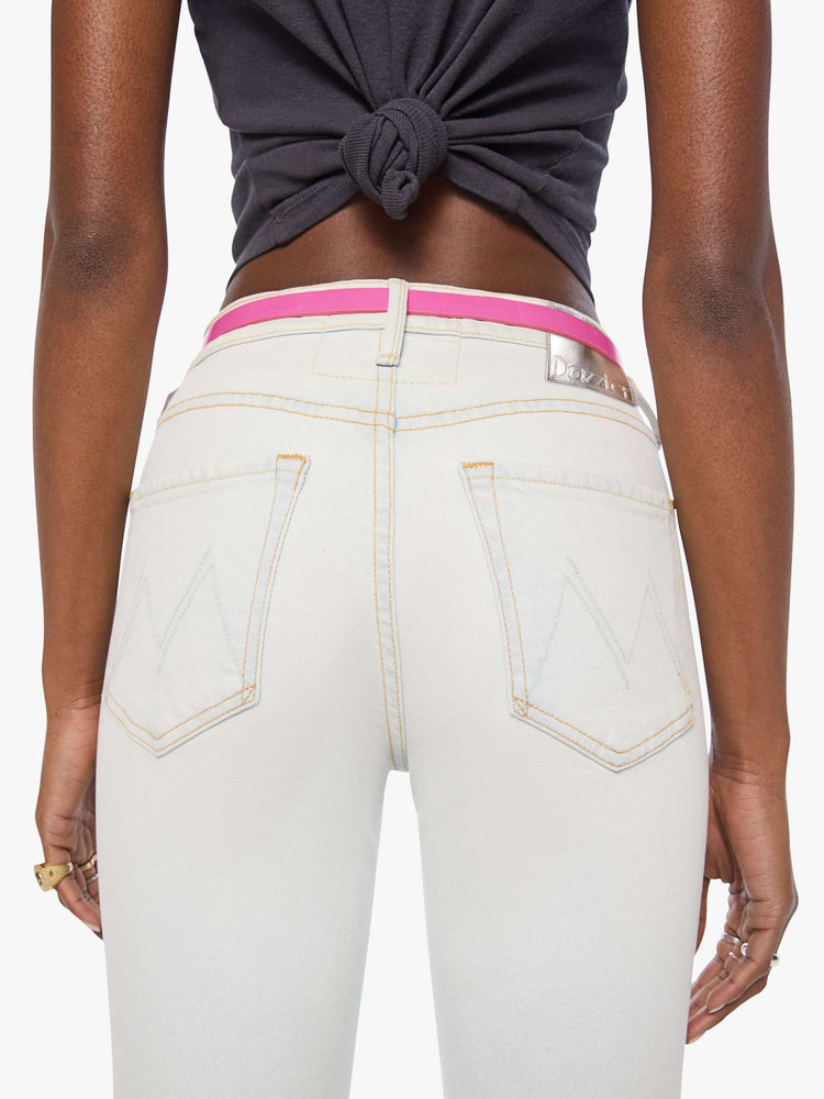 Back close up narrow belt is made from 100% leather with a pastel pink coating and silver hardware.