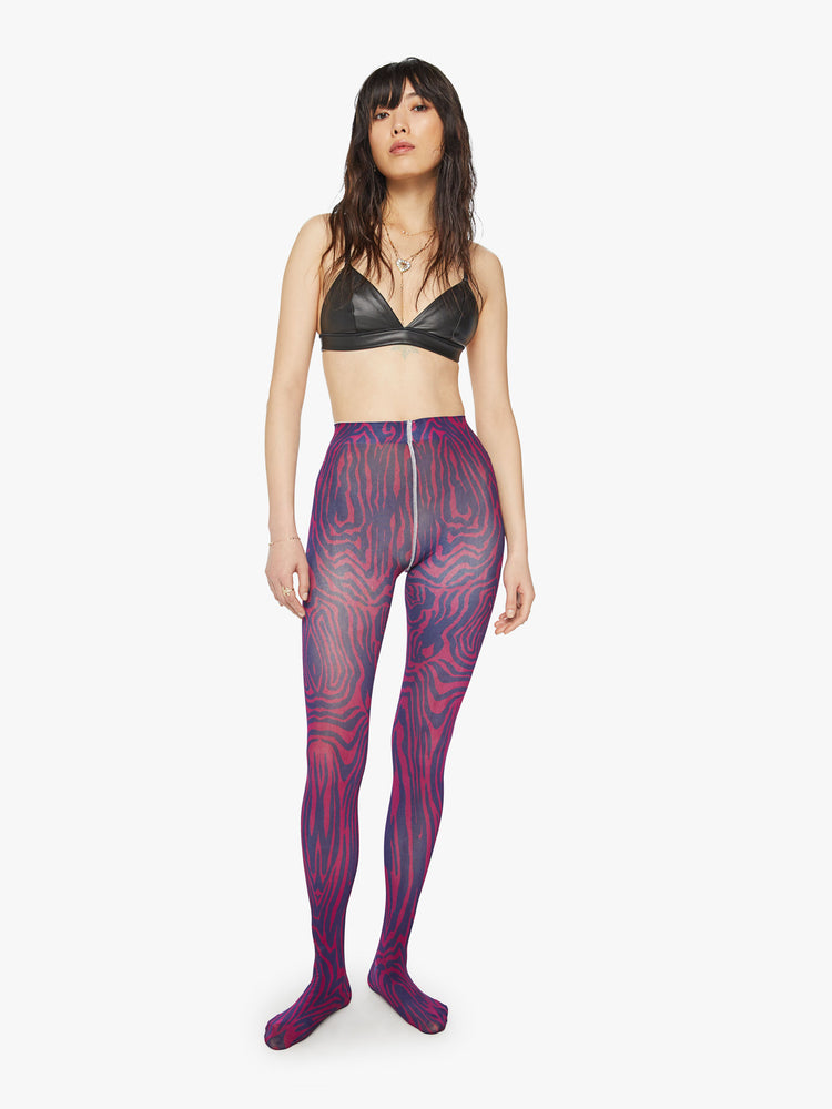 Front view of a woman high-waisted tights with a closed toe in a trippy pink and blue zebra print with an opaque finish.