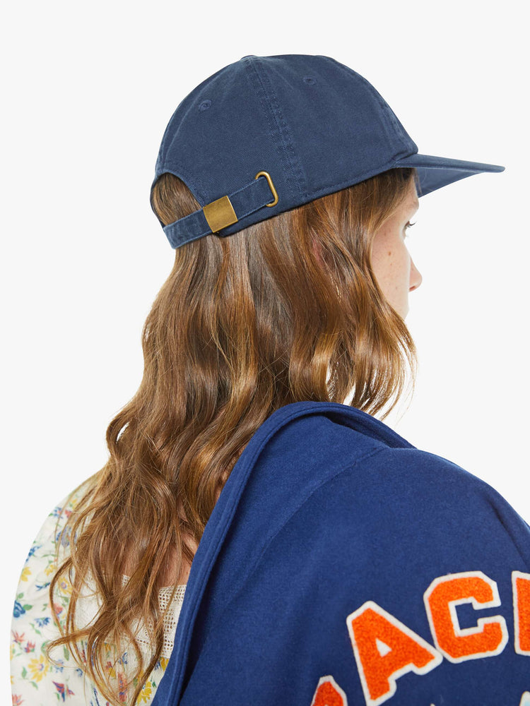 Back model view of a dad hat designed in navy 100% cotton with an M embroidered in red and white on the front.