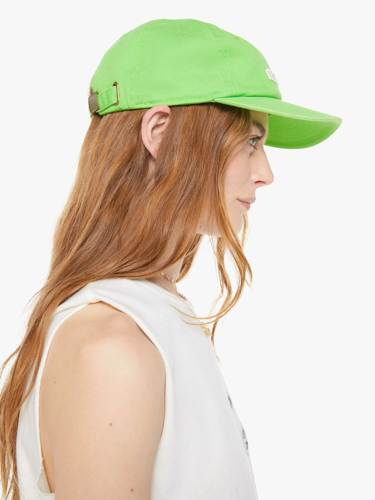 Side on model view with a dad hat designed in lime green.