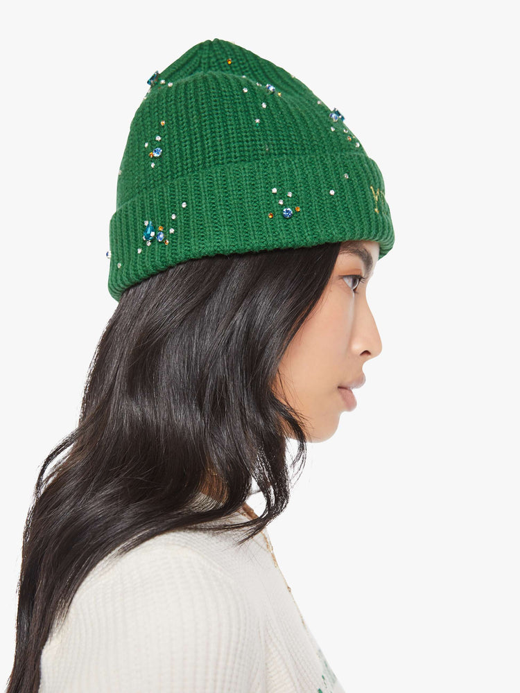 Side view of a green beanie with colorful rhinestone embellishments.