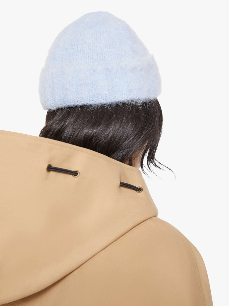 Back view of a blue with an M patch on the front ribbed beanie with a folded hem and cozy fit.