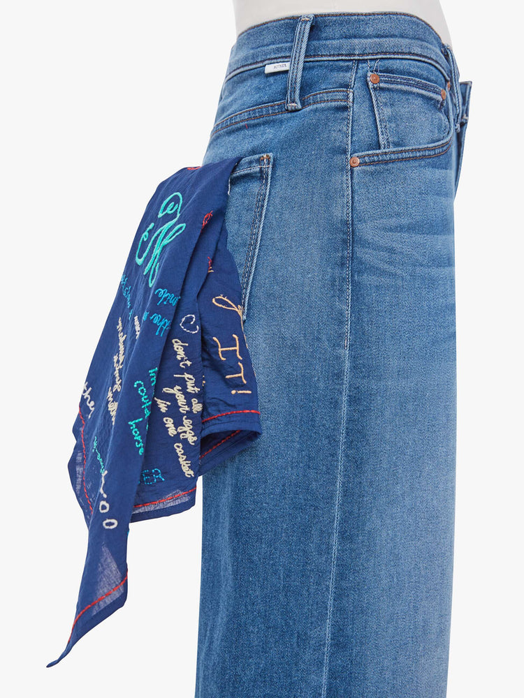 A square scarf designed to be worn around the neck, on your head or tied on a bag.