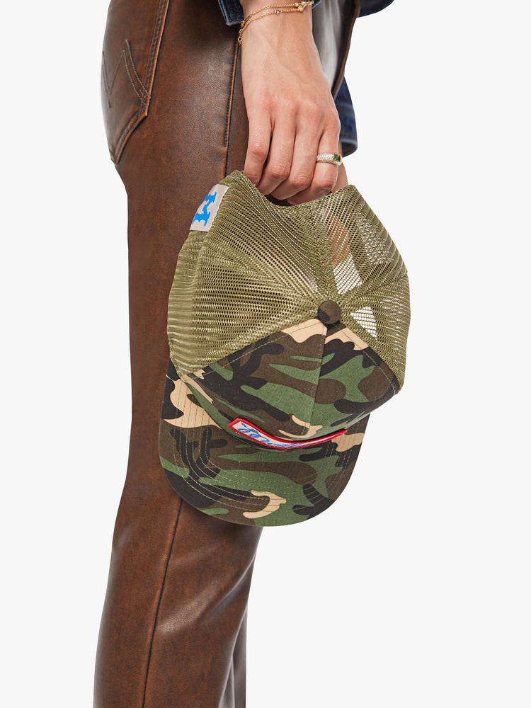 Top view of a woman in a vintage-inspired hat designed in camo featuring a patch with MOTHER's name on the front.