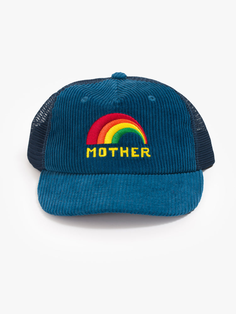 Front view of a vintage-inspired trucker hat designed in blue corduroy and mesh with an embroidered rainbow graphic and MOTHER's name on the front.